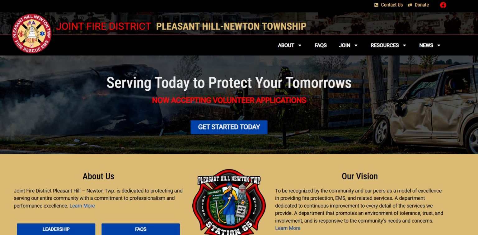 Image of the Joint Fire District website homepage. Displays a banner with firefighters in action beside a wrecked car, text about volunteer applications, and sections for About Us, FAQs, and Vision. Logo and navigation menu are also visible.